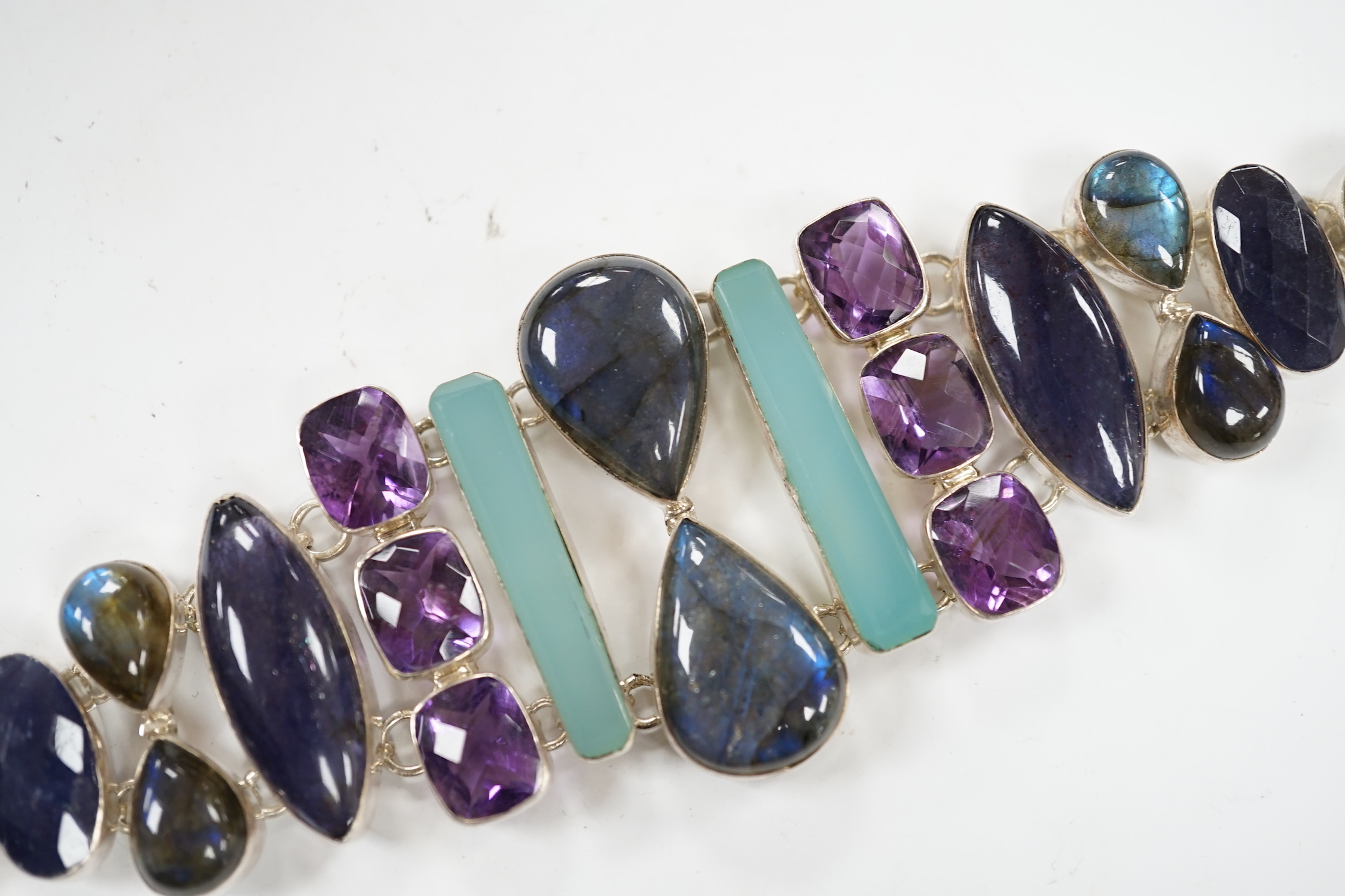 A white metal and multi gem set bracelet, including dyed agate, amethyst and labradorite, 21cm.